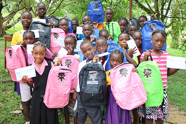 kids holding up new book bags